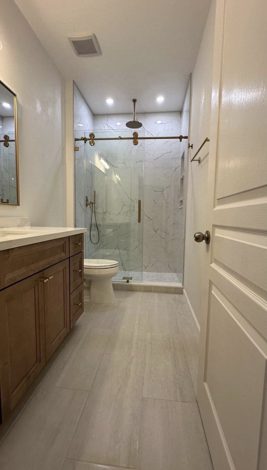 Marble-look bathroom with glass shower