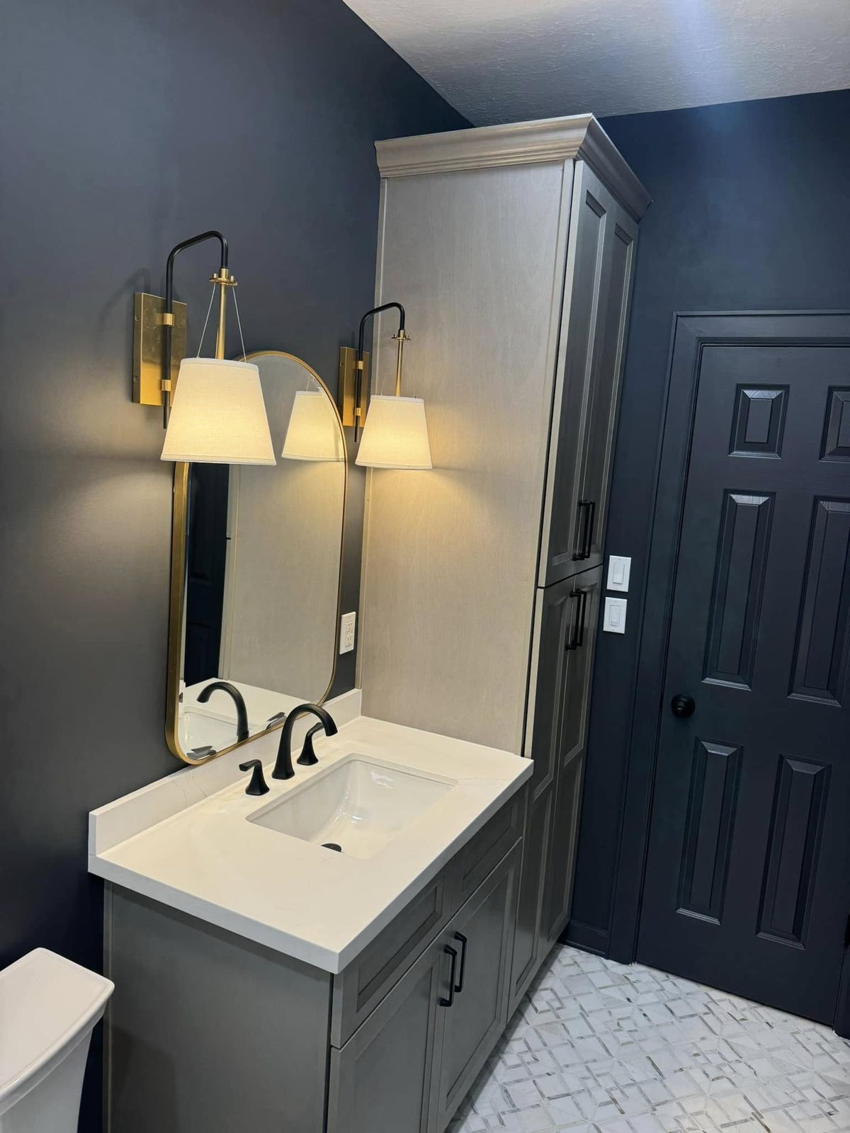 Bathroom with navy accent walls and white vanity
