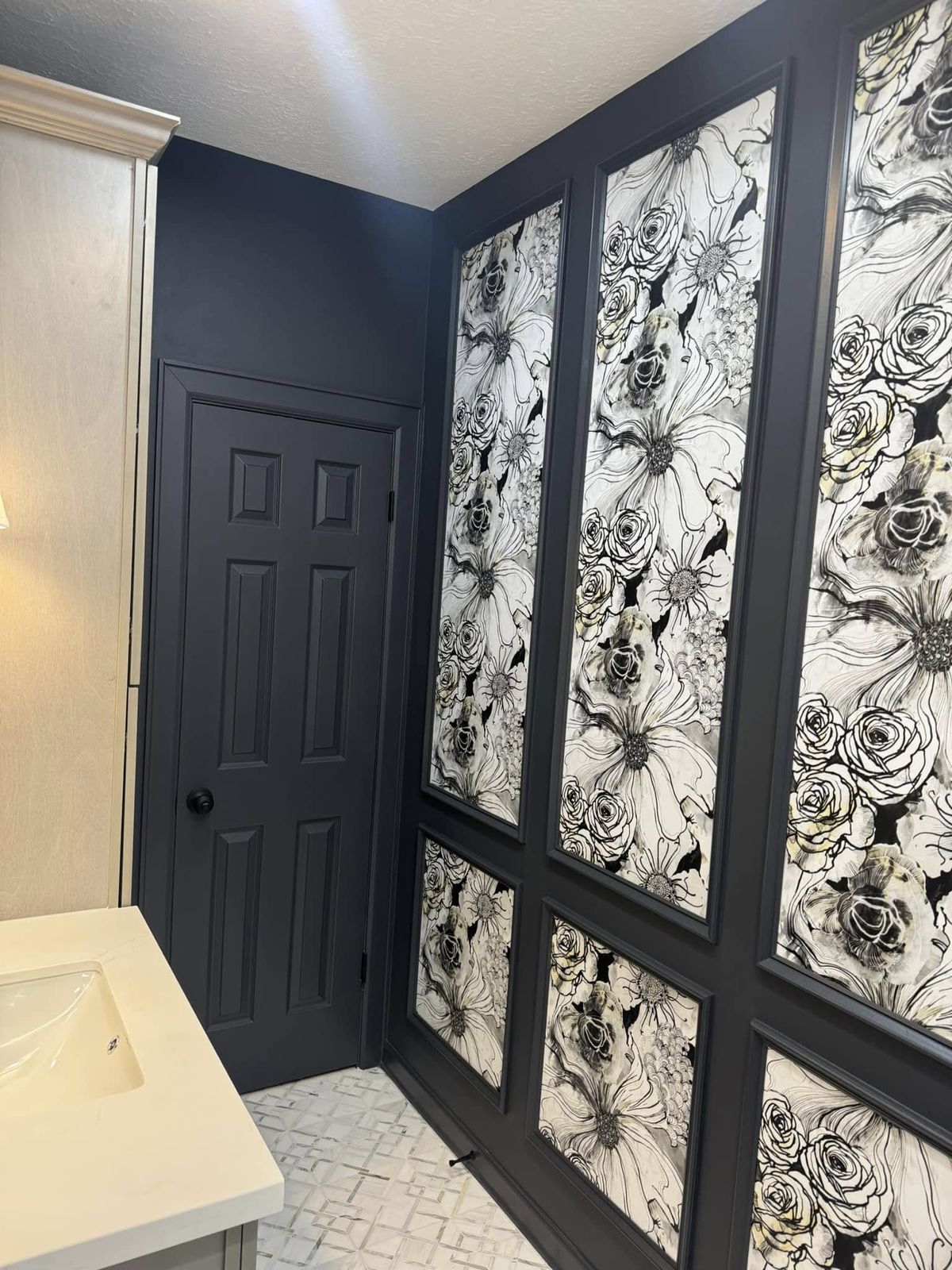 Black and white floral wallpaper accent wall